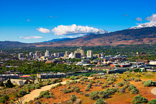 Downtown Reno skyline, Nevada, with hotels, casinos and the surrounding High Eastern Sierra foothills