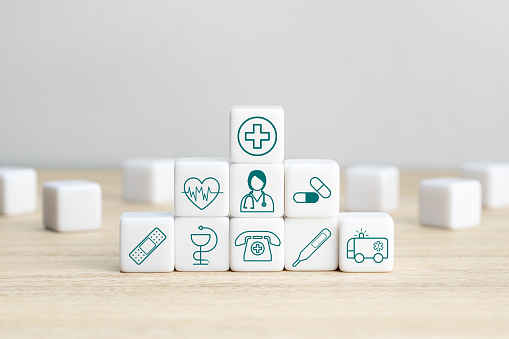 Health Insurance Concept. Pile of white blocks with healthcare medical icons. Copy space