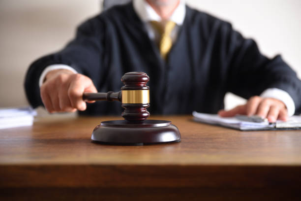 Judge passing sentence by hitting with gavel closeup stock photo