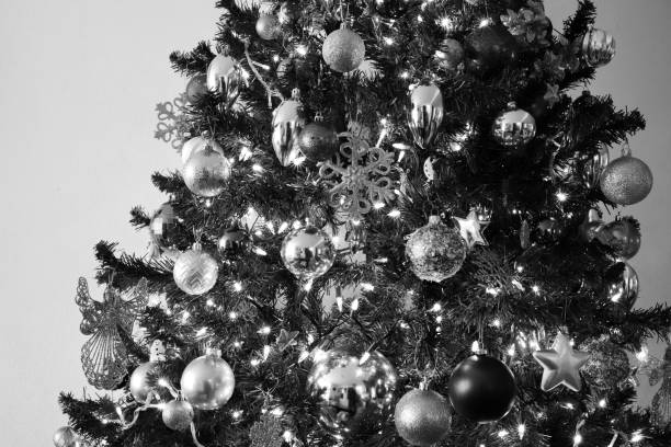 istock Grayscale of a Christmas tree with shiny ornaments 1454157675