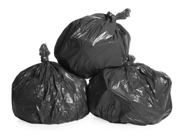 istock Black trash bags full of garbage on white background 1454158815