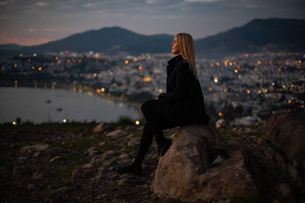 istock Depressed Woman Watching Cityscape at Sunset 1454159254