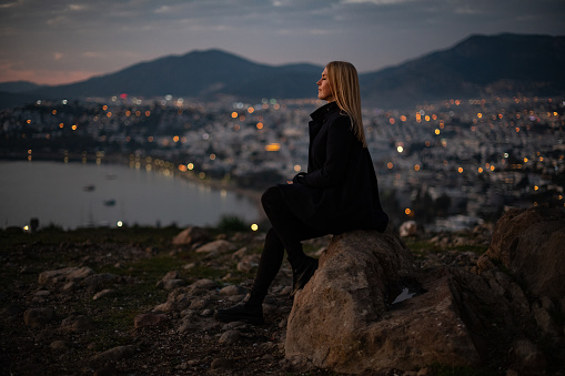 Depressed Woman Watching Cityscape at Sunset
