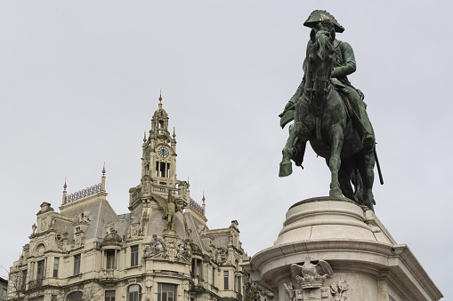 The D. Pedro statue with a historical building in the background in Porto, Portugal
