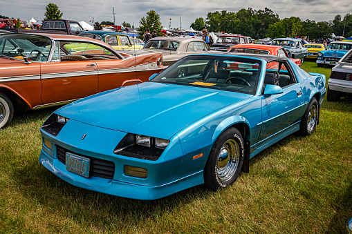 Iola, WI - July 07, 2022: High perspective front corner view of a 1990 Chevrolet Camaro RS Coupe at a local car show.