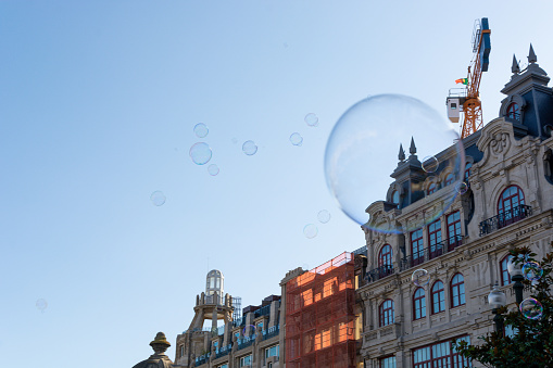 Soap bubbles and Aliados Avenue in Porto city on the background