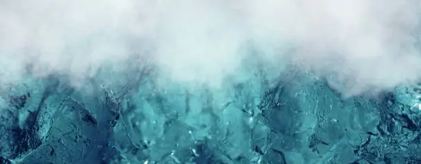 Photo of The cool ice background with fog.