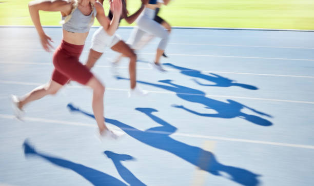 sports, race and running on track together with athletes in outdoor stadium. fitness, exercise and blur of people in racing competition for olympics event. speed, fast and runners on running track - track and field stadium imagens e fotografias de stock