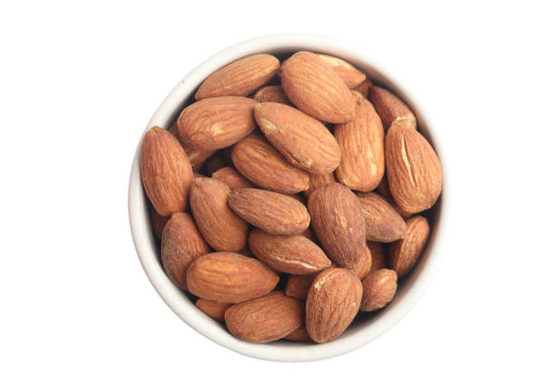 istock Almonds in a cup on a white background 1454173007