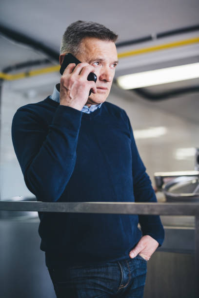 istock Craft brewery owner talking on mobile phone doing business 1454173015