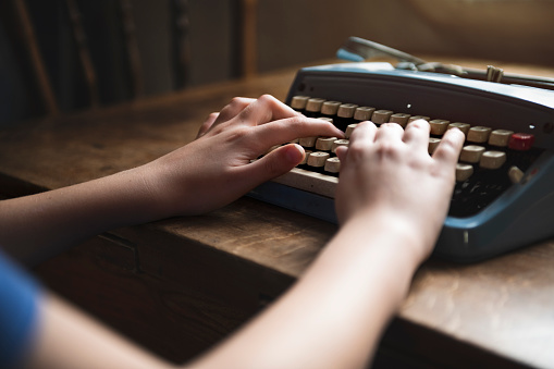 Typing on old typewriter close up