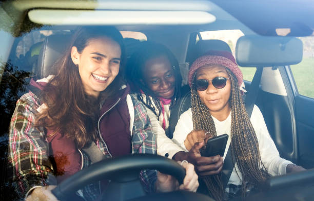 istock Multiracial friends using gps on their mobile phone during a road trip 1454173802