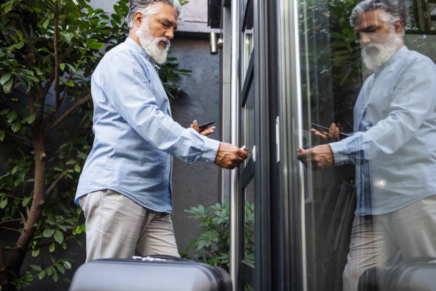 istock Man unlocking an entrance door with a key 1454174044