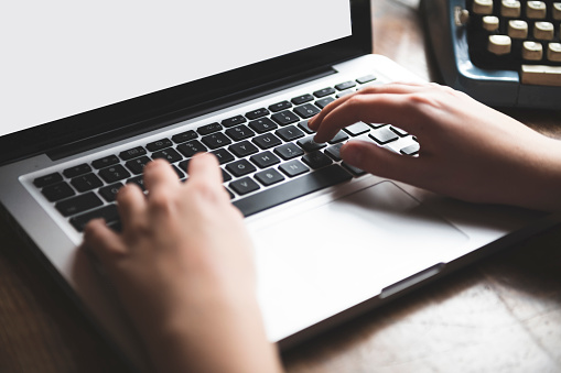 Cloe up of hands typing on laptop