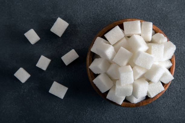 istock White sugar cubes in bowl on a black background 1454176170