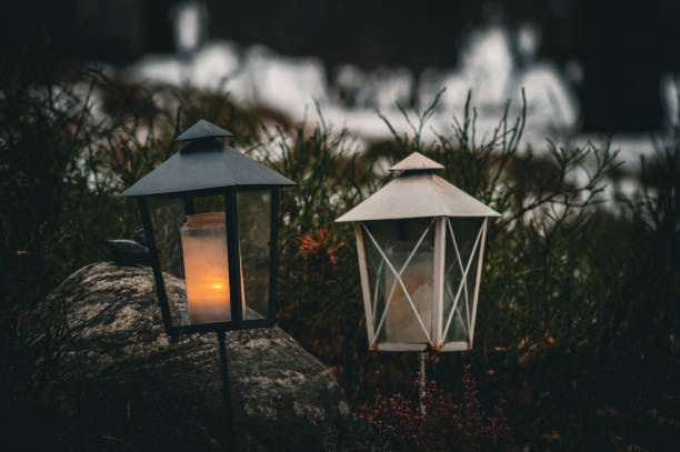 istock Close-up of illuminated lantern on graveyard during winter 1454177574