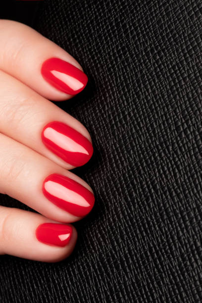 istock Female hand with red nails 1454179890
