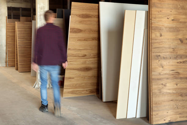 Man walking between wooden boards