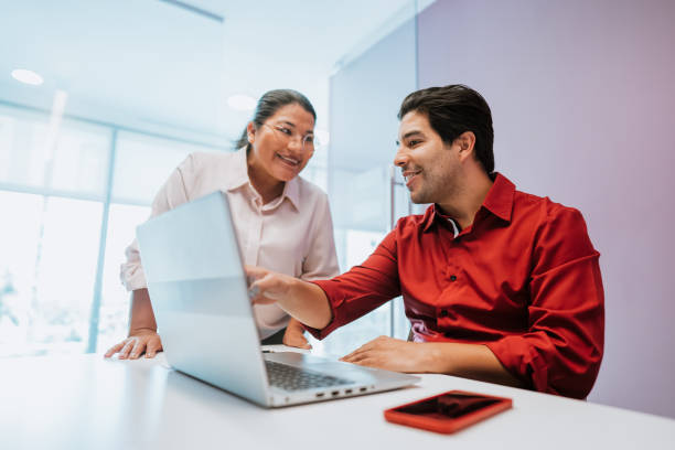 istock Two coworkers looking at the laptop 1454180276