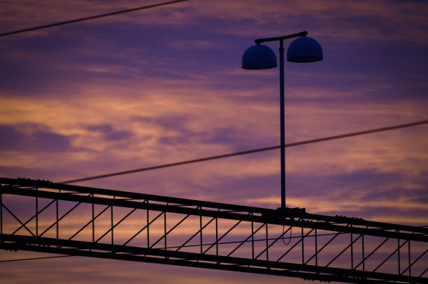 Low angle view of street light against sky during sunset