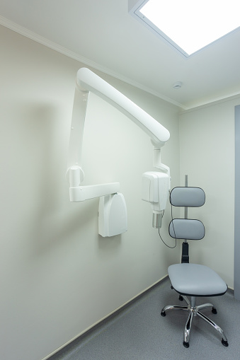 Dental room xray machine and chair for patient. The device is designed for the production of X-ray images of the jaw of patients.