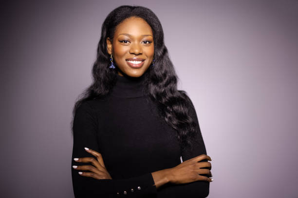 istock Attractive young African woman on grey background 1454185438