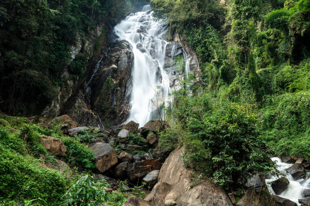 istock Beautiful deep forest waterfall at Thailand. 1454187673