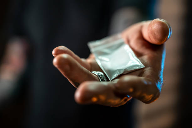 Cocaine Man holding in hands small bag with cocaine drug addiction tattoos stock pictures, royalty-free photos & images