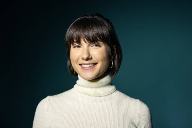 istock Attractive young woman smiling against green background 1454187868