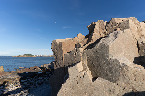 photo of stack of stones on beach with sun light