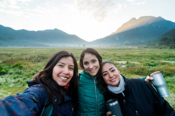 istock Three young women taking selfie during hike 1454189279