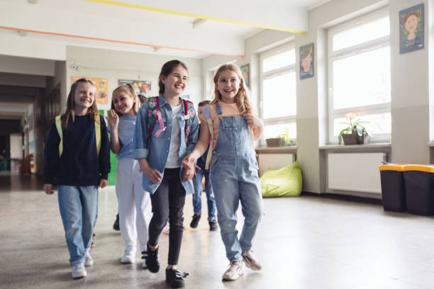 istock School girls walking the school corridor 1454190917