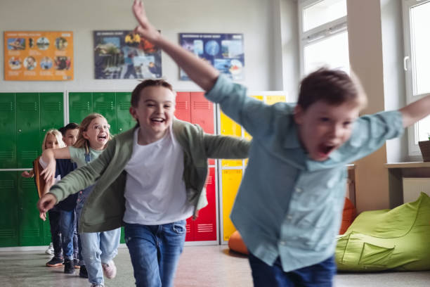 istock School kids running the school corridor 1454190934
