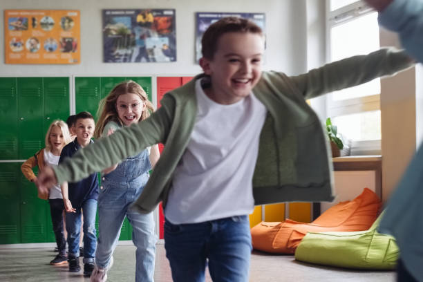 istock School kids running the school corridor 1454190964