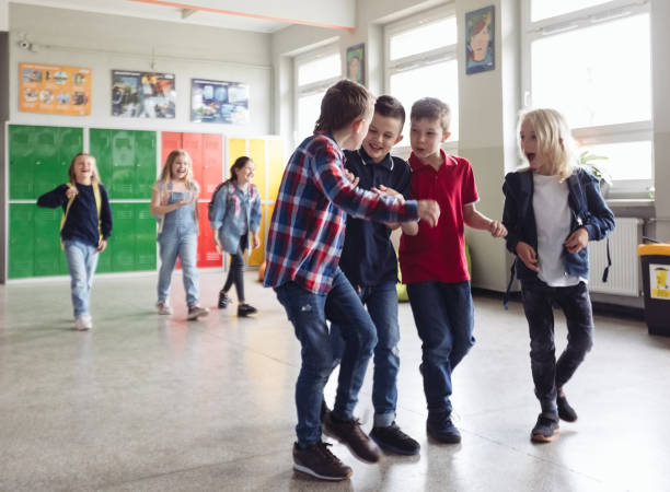 istock School kids walking the school corridor 1454191013