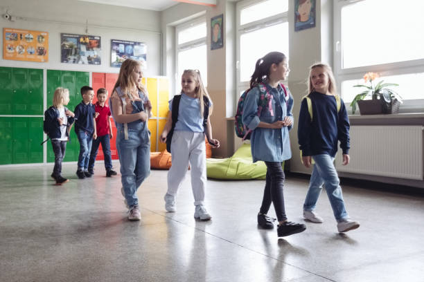 istock School kids walking the school corridor 1454191072