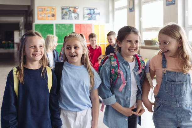istock School kids walking the school corridor 1454191100