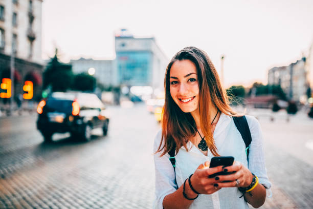 istock Millennial in the city using mobile app for taxi calling 1454191116