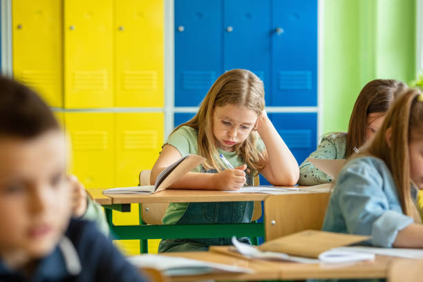 istock Schoolgirl sitting in the classroom 1454191254