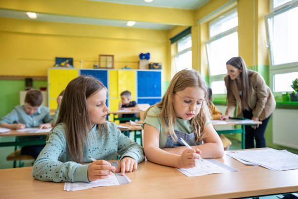 istock Schoolgirls learning in the classroom 1454191436