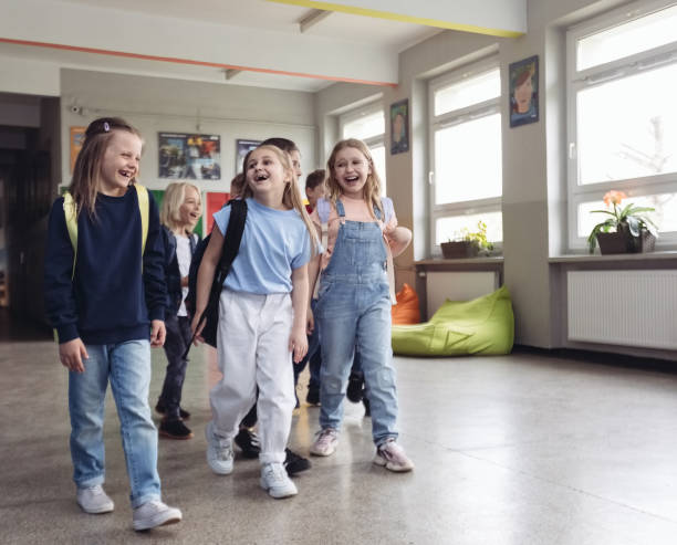 istock Schoolgirls walking the school corridor 1454191579