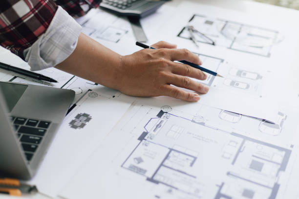 istock Architects in the design office are drawing blueprints and planning construction projects. 1454192396