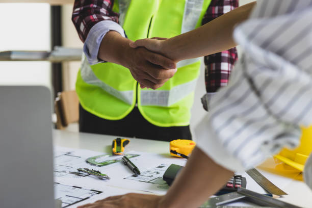 istock Architects and contractors join hands to agree to work together. 1454192412