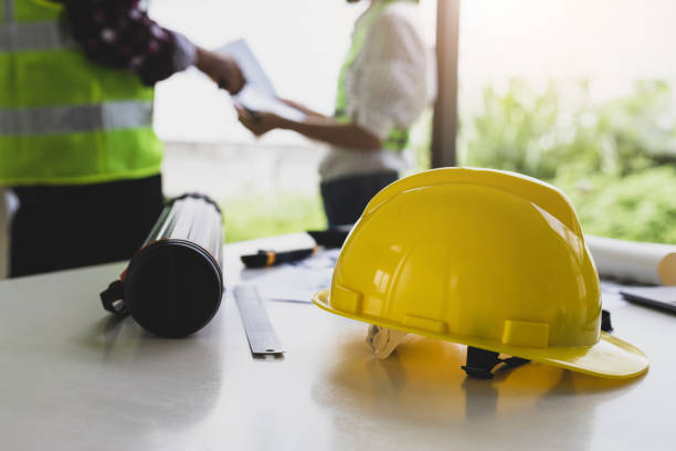 istock Architect and engineer colleagues brainstorm design work on blueprint planning ideas of construction projects. Construction engineering design inspector team. 1454192418