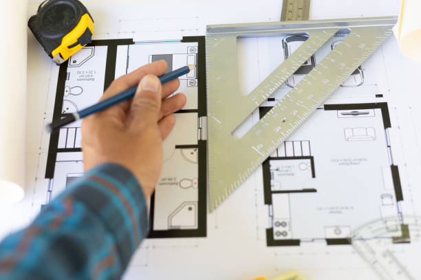 istock Architects in the design office are drawing blueprints and planning construction projects. 1454192474