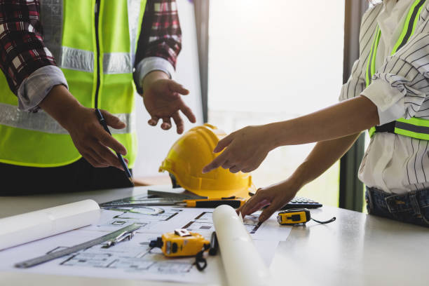 istock Architect and engineer colleagues brainstorm design work on blueprint planning ideas of construction projects. Construction engineering design inspector team. 1454192475