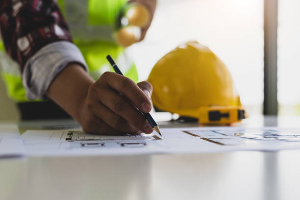 istock Architects in the design office are drawing blueprints and planning construction projects. 1454192490