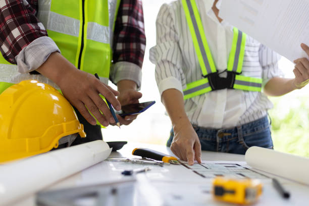istock Architect and engineer colleagues brainstorm design work on blueprint planning ideas of construction projects. Construction engineering design inspector team. 1454192515