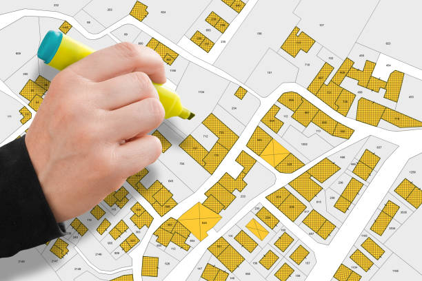 istock Imaginary cadastral map with buildings, land parcel and vacant plot printed on paper 1454192628