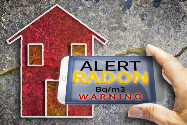 Portable information device for monitoring radioactive gas radon - radon testing concept image against a cracked wall stock photo